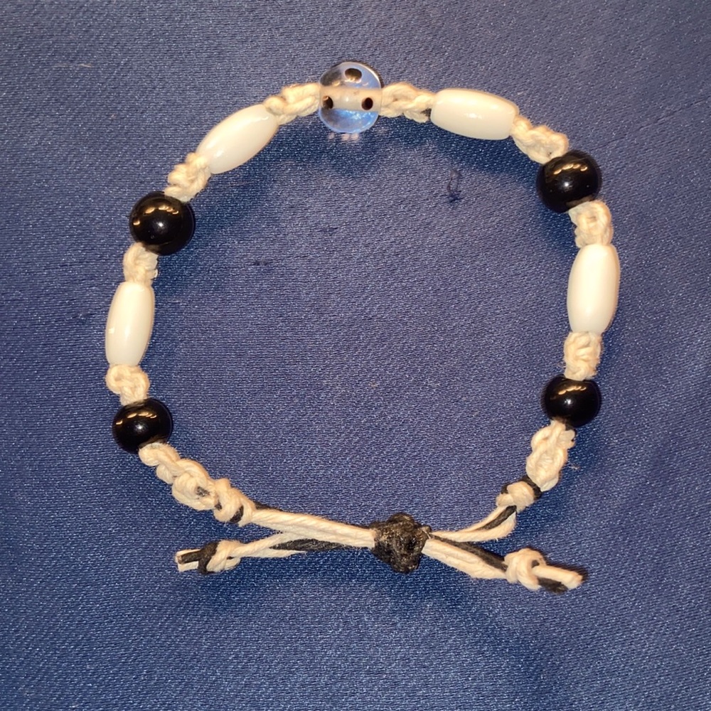 This bracelet is braided with hemp with glass beads
